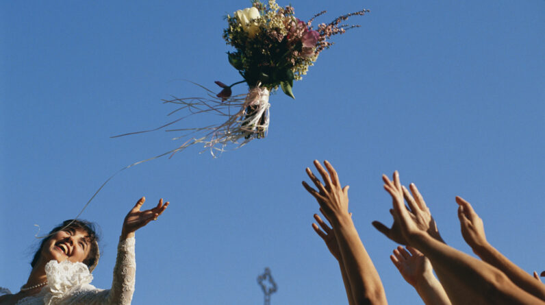 bride throwing bouquet