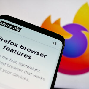 Smartphone with webpage of open-source web browser Mozilla Firefox on screen in front of logo.