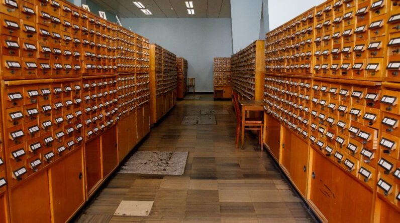Bricklayer laying bricks on mortar on new residential house construction.