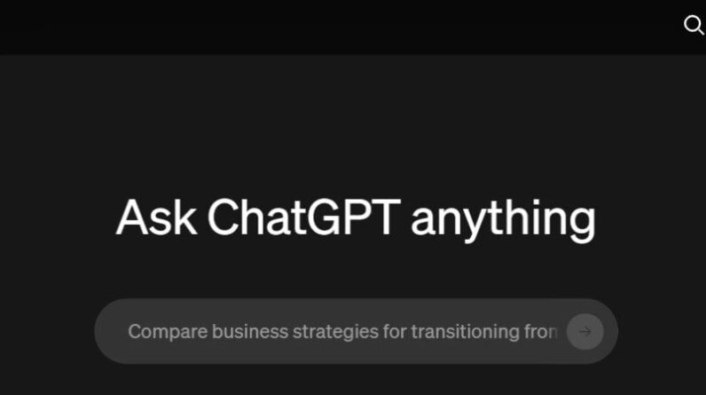 Close-up of a man holding binoculars in mountains.