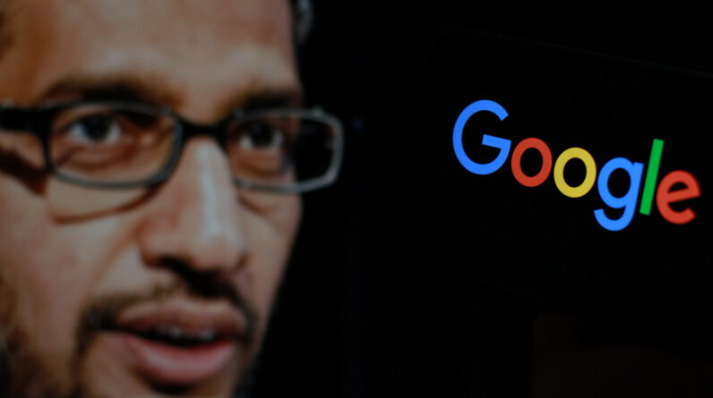 In this photo the Google logo is displayed on the smartphone screen with CEO Sundar Pichai in the background.