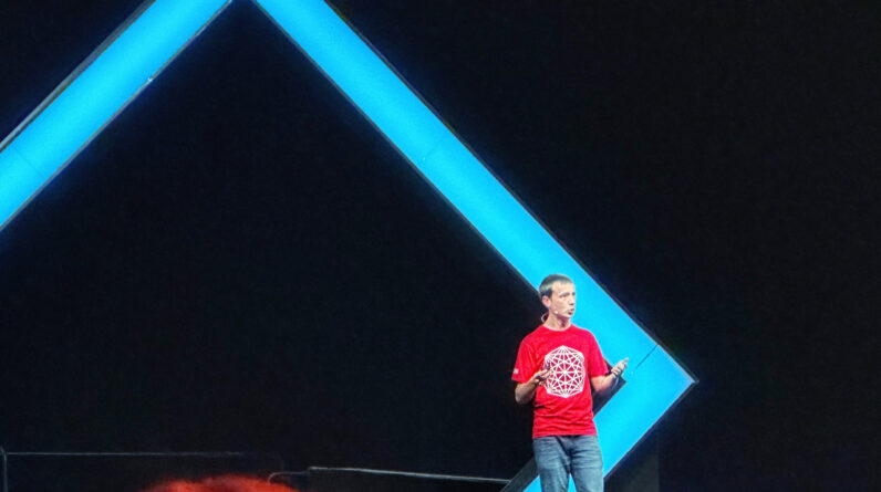 Man getting ready to climb up mountain looking up at the challenge before him planning path.